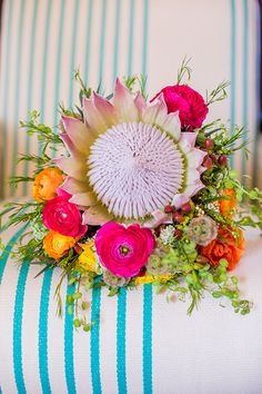 A king protea and ranunculus bridal bouquet | Brides.com
