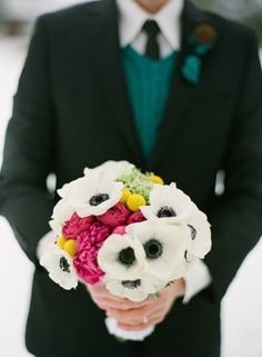 Hot and cold for a winter wedding:  black-centered anemones, fuchsia peonies and bright yellow craspedia -- with a cable-knit "sweater" handle!