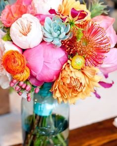 Beautiful bouquet with succulents, peonies, dahlias, ranunculus and pin cushion protea with a lovely bright blue. So colorful and so wonderful!